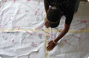 imge of man looking at a hand-drawn map